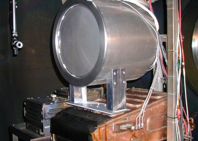 LM4 engine mounted on PEPL thrust stand. A vacuum rated camera mounted on a rotational theta table (shown to the left of the engine) allowed visual monitoring of the discharge cathode during ignition and provided flexibility in diagnosing any operating problems.